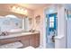 Bathroom with long vanity and a peek into the water closet with a toilet at 16601 W Course Dr, Tampa, FL 33624