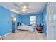 Bright bedroom features a ceiling fan, blue walls and a cozy atmosphere at 16601 W Course Dr, Tampa, FL 33624