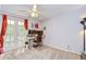 Bright bedroom with a ceiling fan, desk with monitors, and sliding doors for natural light at 16601 W Course Dr, Tampa, FL 33624