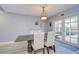 Dining room featuring wood-look flooring, elegant light fixture, and a backyard view at 16601 W Course Dr, Tampa, FL 33624