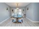 Dining room featuring wood-look flooring, an elegant light fixture, and sliding doors at 16601 W Course Dr, Tampa, FL 33624