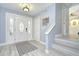 Welcoming foyer with a decorative glass door and stairs at 16601 W Course Dr, Tampa, FL 33624