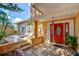 Inviting front entry with a red door, decorative fountain, and stone walkway at 16601 W Course Dr, Tampa, FL 33624
