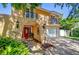 Home featuring arched doorway, red door and wrought iron balconets at 16601 W Course Dr, Tampa, FL 33624