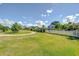 Expansive front lawn with a winding path and charming white picket fence, perfect for outdoor enjoyment at 16601 W Course Dr, Tampa, FL 33624