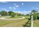 A tranquil backyard with a white picket fence with scenic views of the adjacent lush golf course at 16601 W Course Dr, Tampa, FL 33624