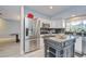Well-lit kitchen features stainless steel appliances, an island, and direct access to the dining room at 16601 W Course Dr, Tampa, FL 33624