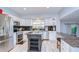 Modern kitchen features stainless steel appliances, a central island, and sleek granite countertops at 16601 W Course Dr, Tampa, FL 33624