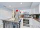Bright kitchen featuring stainless steel appliances, a center island, and white cabinetry at 16601 W Course Dr, Tampa, FL 33624