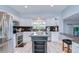 Stylish kitchen features white cabinetry, granite countertops, and modern stainless-steel appliances at 16601 W Course Dr, Tampa, FL 33624