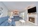 Bright living room showcases a decorative fireplace, large screen TV, and comfortable sectional seating at 16601 W Course Dr, Tampa, FL 33624