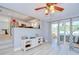 Open living area showcasing wood-look floors and a sliding glass door to the lanai at 16601 W Course Dr, Tampa, FL 33624