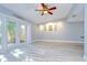 Bright living room with wood-look flooring and glass French doors to backyard at 16601 W Course Dr, Tampa, FL 33624