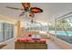 Spacious screened-in patio featuring comfortable seating, a ceiling fan, and seamless access to the pool area for outdoor enjoyment at 16601 W Course Dr, Tampa, FL 33624