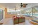 Wide angle shot of a spacious screened-in patio with comfortable seating and ceiling fans, offering a relaxing outdoor retreat at 16601 W Course Dr, Tampa, FL 33624