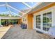 Spacious brick patio with comfortable seating, providing a seamless transition to the backyard and pool area at 16601 W Course Dr, Tampa, FL 33624