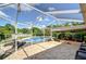 Expansive pool area with brick patio, lounge chairs, and serene backyard views, perfect for outdoor relaxation and entertainment at 16601 W Course Dr, Tampa, FL 33624