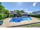 A refreshing backyard pool surrounded by a brick patio and well-maintained landscaping, ideal for summer enjoyment at 16601 W Course Dr, Tampa, FL 33624