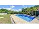 Stunning pool with brick patio, framed by lush greenery, offering a private and relaxing outdoor oasis for leisure and recreation at 16601 W Course Dr, Tampa, FL 33624