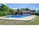 A beautiful backyard pool with brick patio, mature landscaping, and a screened-in lanai for year-round enjoyment at 16601 W Course Dr, Tampa, FL 33624