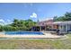 A luxurious backyard pool with brick patio, screened-in lanai, and lush landscaping, perfect for relaxation and outdoor entertaining at 16601 W Course Dr, Tampa, FL 33624