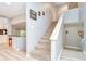 Carpeted staircase with modern white railing and gray walls at 16601 W Course Dr, Tampa, FL 33624