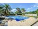 Sparkling blue swimming pool surrounded by a brick patio and lush greenery, ideal for outdoor fun at 16601 W Course Dr, Tampa, FL 33624