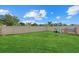 Large, well-maintained backyard enclosed by a tall white fence, featuring a playhouse and plenty of green space at 3270 Rock Sound St, Bradenton, FL 34208