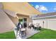 Inviting backyard seating area under a sunshade, with a smooth patio, a lush green lawn and easy access to the house at 3270 Rock Sound St, Bradenton, FL 34208