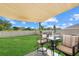 Cozy backyard with lush green grass, patio seating, and a shaded canopy, perfect for outdoor relaxation at 3270 Rock Sound St, Bradenton, FL 34208
