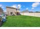 Spacious backyard with a well-maintained lawn, patio seating and a privacy fence on a sunny day at 3270 Rock Sound St, Bradenton, FL 34208