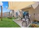 Relaxing backyard features comfortable seating under a sunshade canopy, complemented by lush greenery and potted plants at 3270 Rock Sound St, Bradenton, FL 34208