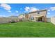 Spacious backyard with a lush green lawn, patio furniture, and a play area, perfect for outdoor activities at 3270 Rock Sound St, Bradenton, FL 34208