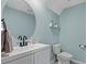 Well-lit half-bath features a round mirror, modern faucet and fixture, and a clean white vanity at 3270 Rock Sound St, Bradenton, FL 34208