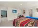 Bright bedroom featuring Southwestern-themed decor, sitting area and ensuite bath access at 3270 Rock Sound St, Bradenton, FL 34208