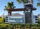 Evergreen Estates community entrance with stone pillars, decorative pergola, and lush landscaping at 3270 Rock Sound St, Bradenton, FL 34208