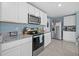 Updated kitchen with stainless appliances, granite countertops, and plenty of storage space at 3270 Rock Sound St, Bradenton, FL 34208