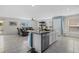 Open-concept kitchen with granite countertops, stainless appliances, island and a view of the living area at 3270 Rock Sound St, Bradenton, FL 34208