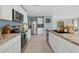 Modern kitchen featuring granite counters, stainless appliances, and ample white cabinetry at 3270 Rock Sound St, Bradenton, FL 34208