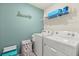 Well-equipped laundry room with a modern washer, dryer, and shelving for supplies, making chores a breeze at 3270 Rock Sound St, Bradenton, FL 34208