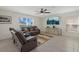 Cozy living room with large window, ceiling fan, and entertainment center at 3270 Rock Sound St, Bradenton, FL 34208