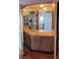 This home features a unique bar area with mirrored accents and glass shelves at 632 Edgewater Dr # 832, Dunedin, FL 34698