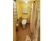 Bright bathroom features a toilet, storage cabinet, and glass-enclosed shower at 632 Edgewater Dr # 832, Dunedin, FL 34698