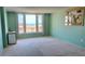 Bedroom featuring large window with natural light and neutral carpet and paint at 632 Edgewater Dr # 832, Dunedin, FL 34698