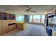 Living room with bay view windows, a ceiling fan, and a yellow sofa at 632 Edgewater Dr # 832, Dunedin, FL 34698