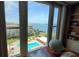 Bright view from the condo overlooking the community pool and bay with blue skies at 632 Edgewater Dr # 832, Dunedin, FL 34698