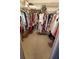Spacious walk-in closet is filled with clothes at 632 Edgewater Dr # 832, Dunedin, FL 34698