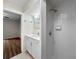 Bathroom featuring white cabinets, quartz countertops, updated shower, and tile floors at 5136 Cedar Hammock Dr, Sarasota, FL 34232