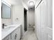 Updated bathroom with white cabinets, quartz countertops, marble floors, and a glass shower at 5136 Cedar Hammock Dr, Sarasota, FL 34232