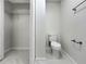 Powder room featuring a pedestal sink and modern fixtures, with neutral color palette and new tile floor at 5136 Cedar Hammock Dr, Sarasota, FL 34232